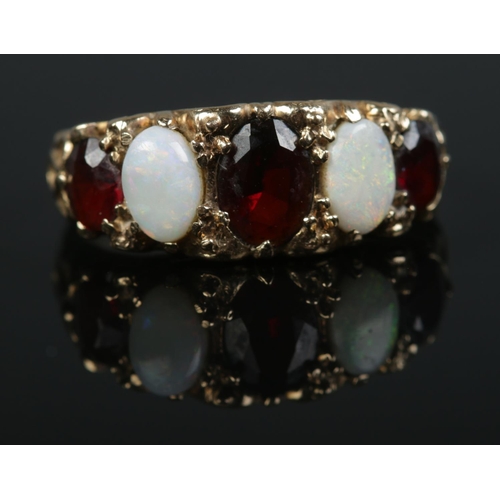 468 - A 9ct gold five stone opal and garnet ring. 

Size O 1/2 
Weight 3.2g