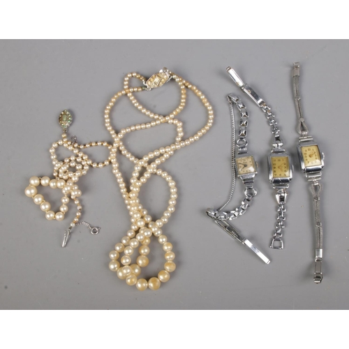 469 - A Pompadour simulated pearl necklace and another silver clasped example together with three ladies w... 