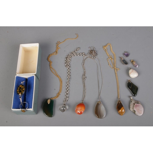 478 - A collection of assorted gem stone pendants and necklaces including tigers eye, amethyst, carnelian,... 