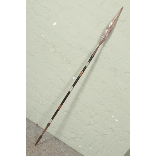 549 - A double sided tribal spear with iron heads on wooden body with copper and metal wrapped decoration.... 