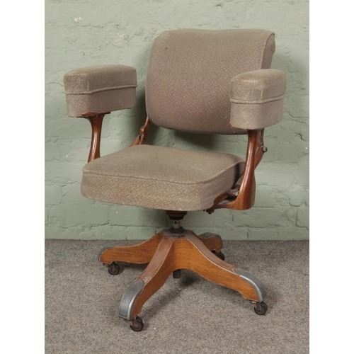 556 - A mid century industrial style desk chair with faux wood design base, possibly manufactured by Tan S... 