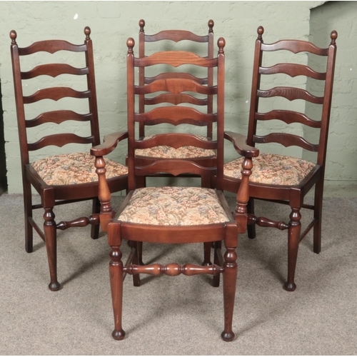 583 - A set of four oak ladder back chairs. Includes one carver example.