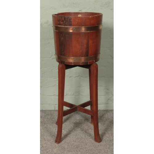 586 - R. A. Lister & Co Ltd oak planter in barrel form on stand.

Hx92cm
Wx36cm