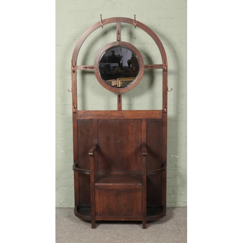 601 - An early 20th century oak hall stand with central circular mirror and storage seat.

Hx194cm
Wx91cm
... 