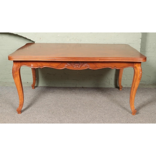 608 - A French provincial walnut extending draw leaf top table with parquetry top and carved frieze on car... 