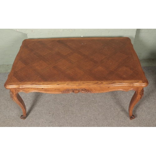 609 - A French provincial oak extending draw leaf top table with parquetry top and carved frieze on carved... 