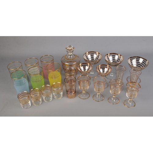 99 - A quantity of gold banded Art Deco glassware including sugar frosted tumblers, champagne glasses and... 