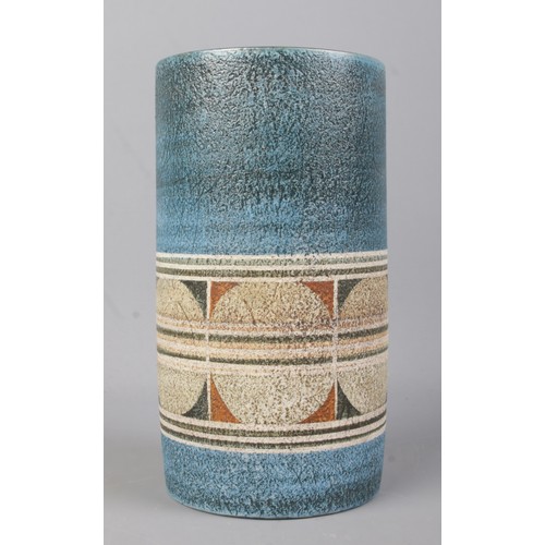 489 - A Troika cylindrical pottery vase. Textured blue ground with lower decorative border, hand painted '... 