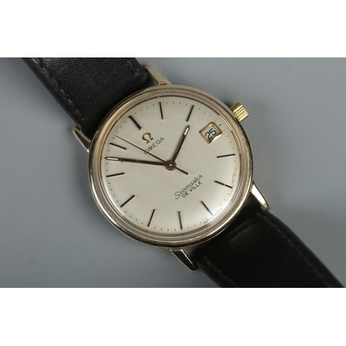 485 - A boxed 9ct gold Omega Seamaster De Ville on leather strap. Featuring baton markers and date display... 