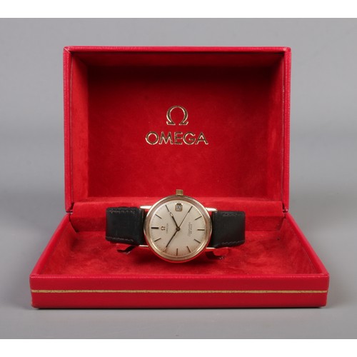 485 - A boxed 9ct gold Omega Seamaster De Ville on leather strap. Featuring baton markers and date display... 