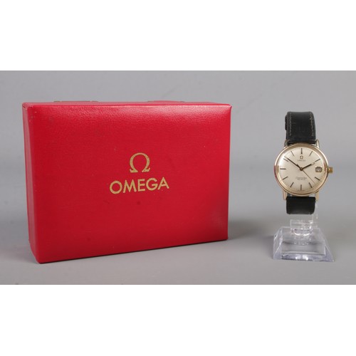 485 - A boxed 9ct gold Omega Seamaster De Ville on leather strap. Featuring baton markers and date display... 