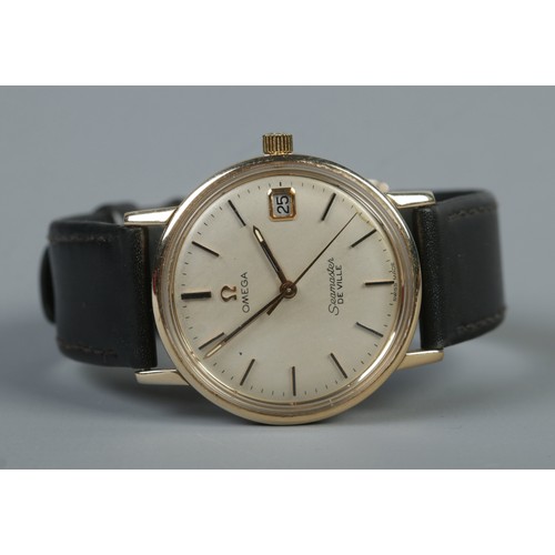 485 - A boxed 9ct gold Omega Seamaster De Ville on leather strap. Featuring baton markers and date display... 