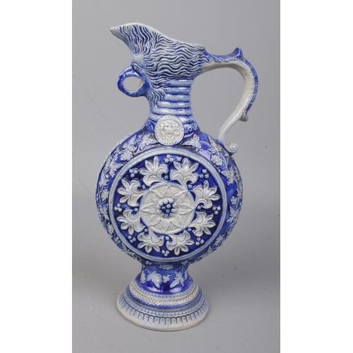 189 - A small German Westerwald ewer featuring bird mask spout. Approx. height 19cm.