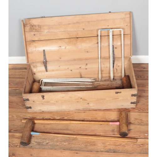 260 - A vintage ash and cast iron croquet set house in pine chest with cast iron handles marked S&S.