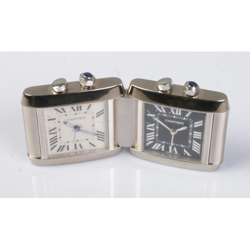 1 - A Cartier Tank Francaise stainless steel dual time folding desk/travel alarm clock. Having white and... 