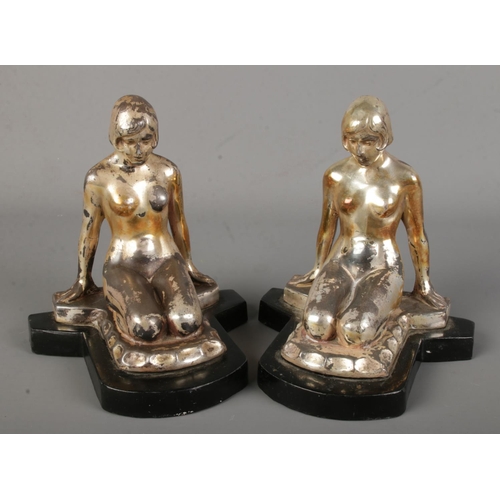 107 - A pair of Art Deco gilt spelter bookends of nude maidens on metal bases.