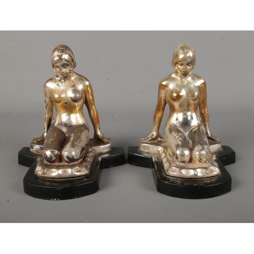 107 - A pair of Art Deco gilt spelter bookends of nude maidens on metal bases.