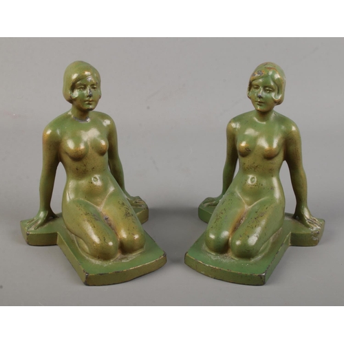 111 - A pair of Art Deco spelter bookends of nude maidens with faux verdigris finish.