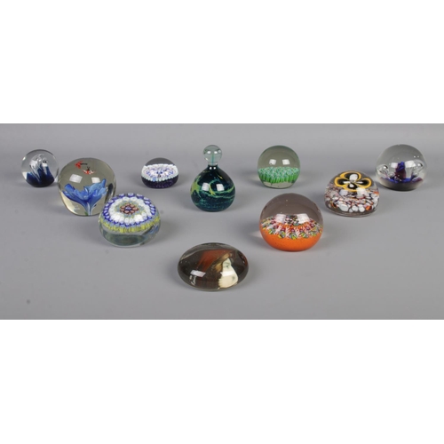 12 - Ten assorted glass paperweights, to include butterfly, portrait and millefiori example with '1837' t... 