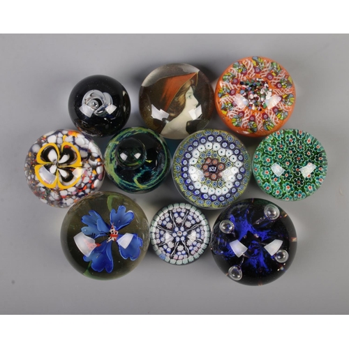 12 - Ten assorted glass paperweights, to include butterfly, portrait and millefiori example with '1837' t... 