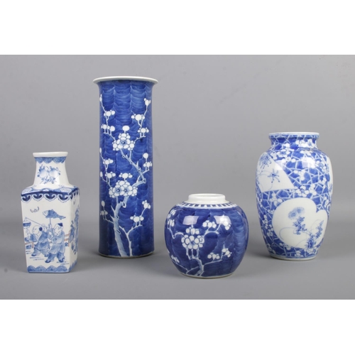 13 - Four pieces of oriental blue and white ceramics, to include tall cylindrical vase (25cm) and ginger ... 