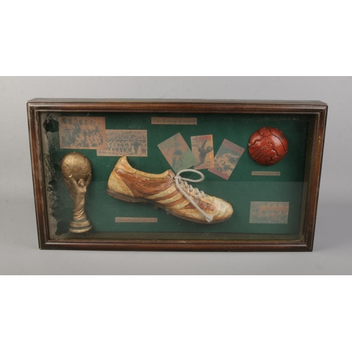 143 - A framed football diorama titled History of Soccer. 28cm x 52cm.