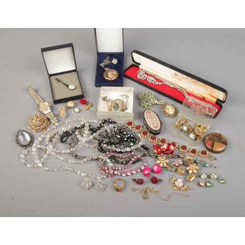 158 - A collection of costume jewellery. Includes gilt metal photograph locket, ladies Talisman wristwatch... 