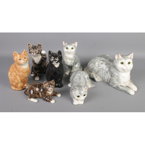 16 - A collection of ceramic cat figures to include four I. Winstanley signed examples and several Just C... 