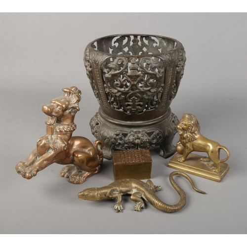 174 - A collection of bronze and brass items. Includes oriental planter stand, box, lizard, lion and a tem... 