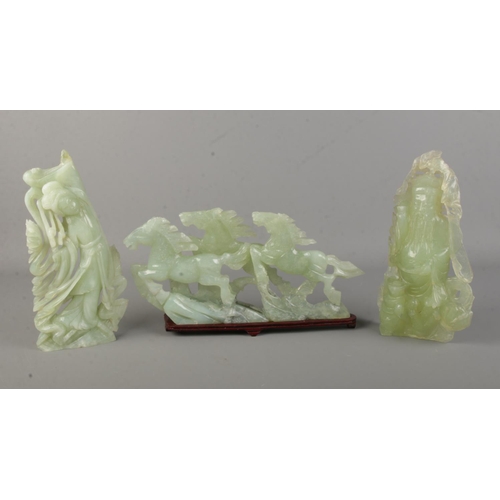 179 - A jadeite sculpture of galloping horses with two other oriental jadeite sculptures of a wise man and... 