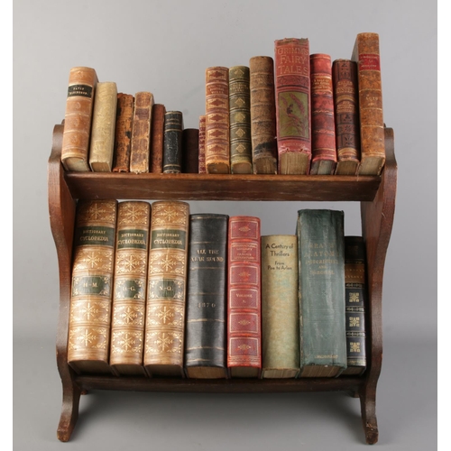 180 - An oak two tier book trough with contents of antique books. Includes British Quadrupeds, Servants Ma... 