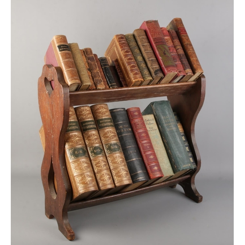 180 - An oak two tier book trough with contents of antique books. Includes British Quadrupeds, Servants Ma... 