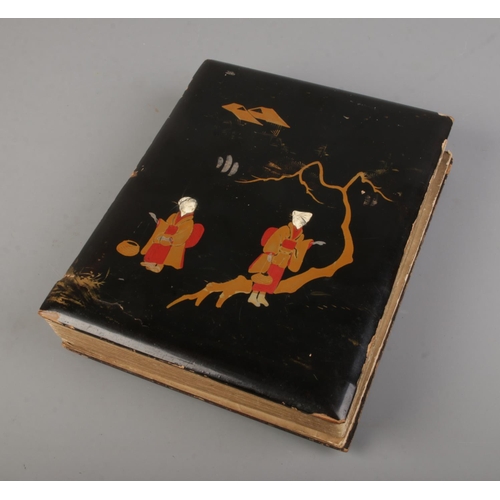 183 - A black lacquered album filled with oriental late 19th early 20th century postcards (approx 100 card... 