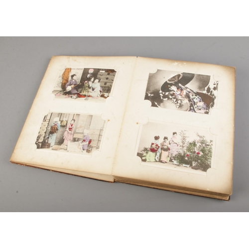 183 - A black lacquered album filled with oriental late 19th early 20th century postcards (approx 100 card... 