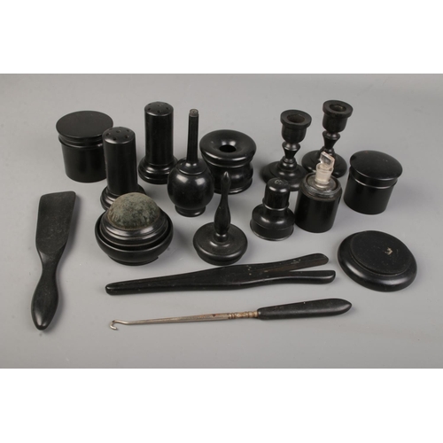 187 - A large quantity of ebony dressing table items including storage jars, candlesticks, shoe horn etc