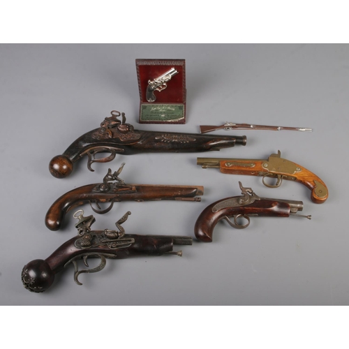 19 - A good collection of decorative reproduction pistols to include presentation plaque.