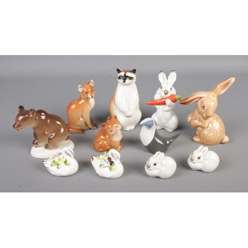 21 - A collection of ceramic animal figures to include Royal Dux Toucan, Royal Doulton cat, assorted Lomo... 