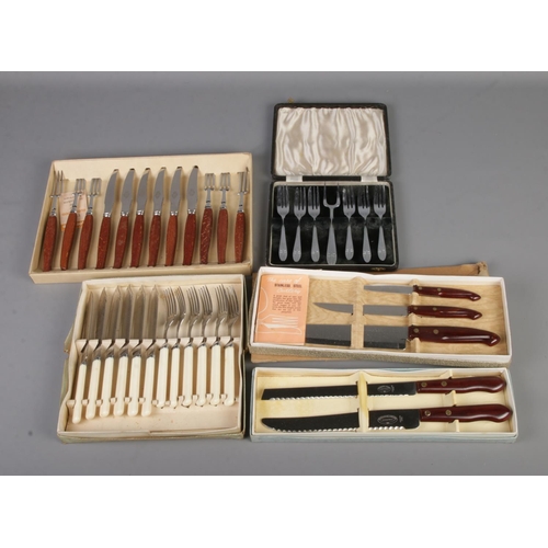 220 - A collection of assorted boxed flatware to include fish knives, pair of bread knives, etc.