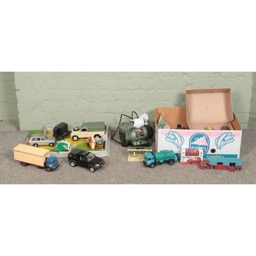 227 - A box of assorted vintage toys and die-cast vehicles, together with a Sealey Mini Air Compressor. In... 