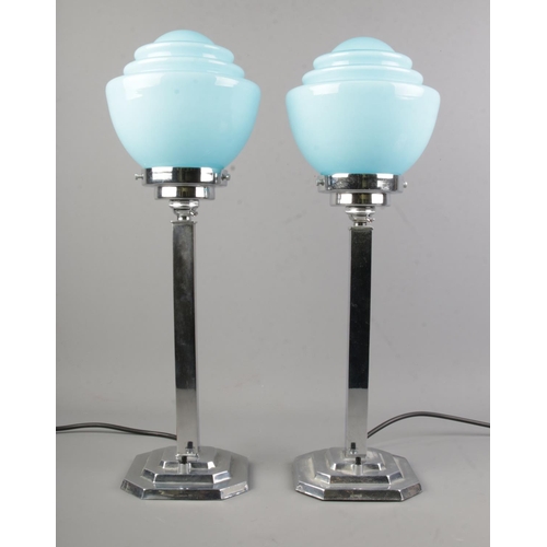 4 - A pair of 1930's Art Deco chrome plated table lamps with stepped base and blue opaline glass shades.