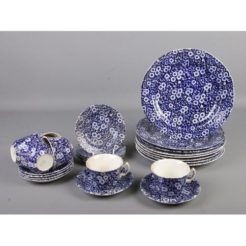 43 - A blue and white calico part dinner service.