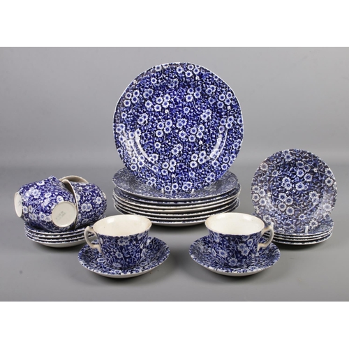 43 - A blue and white calico part dinner service.