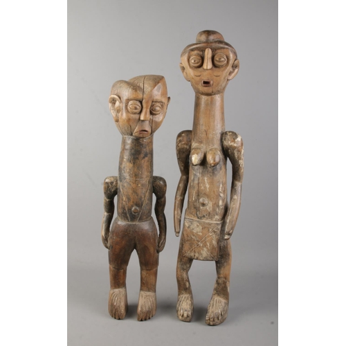 5 - A near pair of African carved hardwood tribal figures. Tallest 60cm.