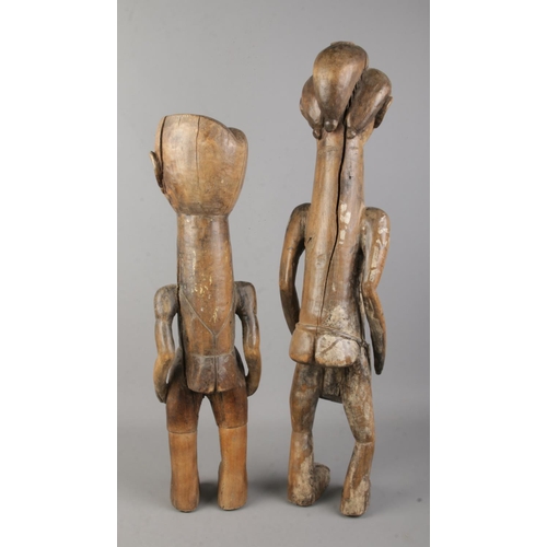 5 - A near pair of African carved hardwood tribal figures. Tallest 60cm.