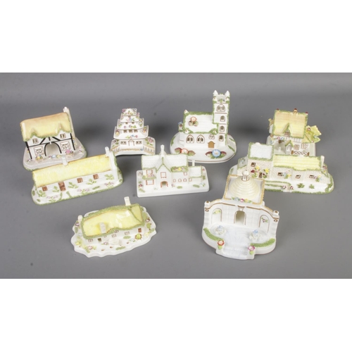 56 - A collection of nine Coalport pastille burners to include Robert Burns' Cottage, Pagoda House, The F... 