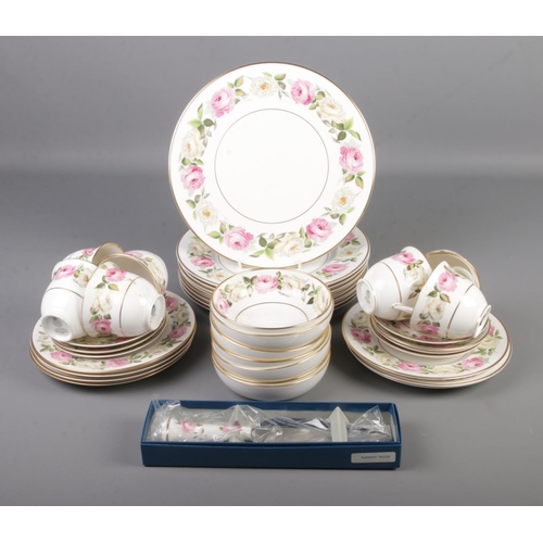 58 - A collection of Royal Worcester dinner and teawares in the Royal Garden Elgar design. Approximately ... 