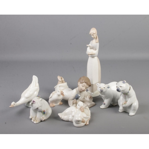 66 - A collection of Lladro and Nao figures. Includes three Lladro polar bears.