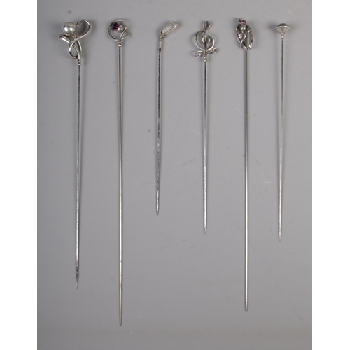 473 - A collection of six silver hat pins including golf club and amethyst examples