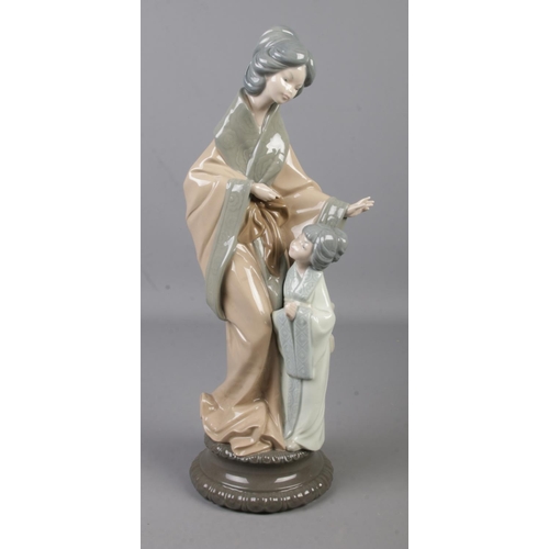 477 - A Nao figure group of a Geisha mother and child. Height 37cm.