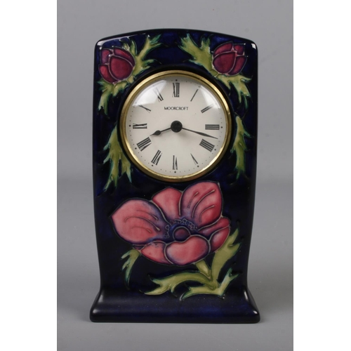 482 - A Moorcroft pottery clock decorated in the Anemone design. Impressed factory mark and signed to base... 